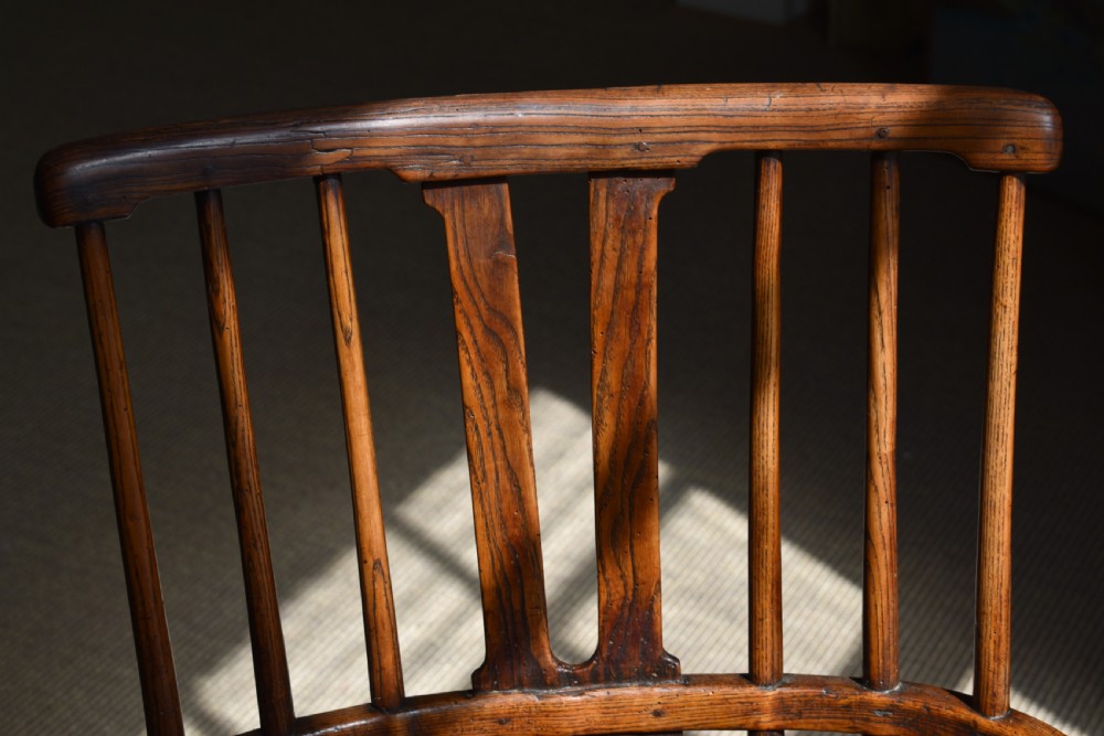 A George III wooden Windsor armchair featuring a shaped saddle seat, comb back rest with splat, and cabriole front legs. View V