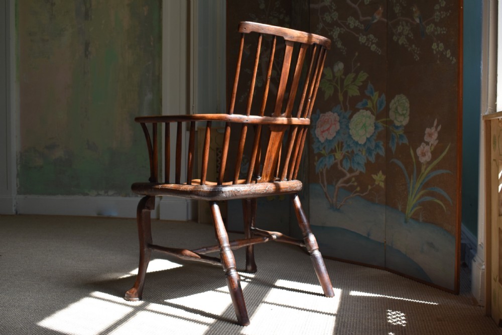 A George III wooden Windsor armchair featuring a shaped saddle seat, comb back rest with splat, and cabriole front legs. View VI