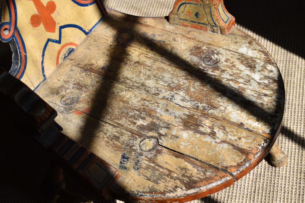 A Swedish folk art wooden armchair with a carved backrest featuring yellow, red, and blue painted details. View VIII