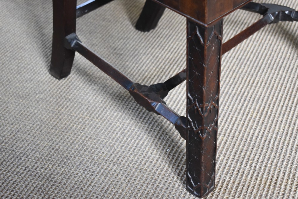 A pair of dark mahogany side chairs with intricate pierced back splats, carved square legs with fretwork, and tapestry fabric seats. View III