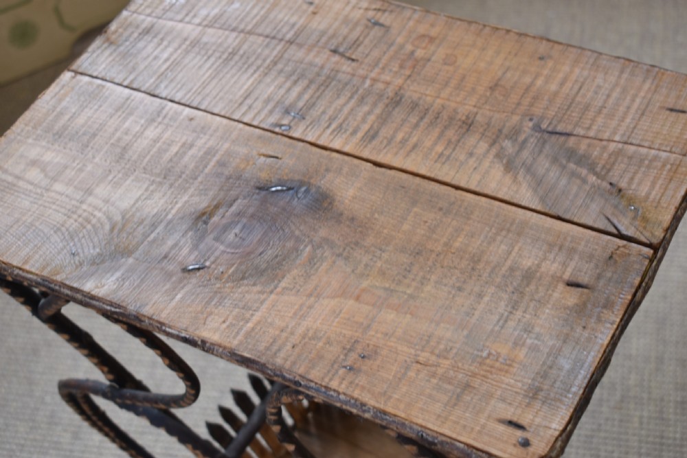 An antique folk art side table crafted from dark bent twigs with decorative notched patterns and arched bracing. View III