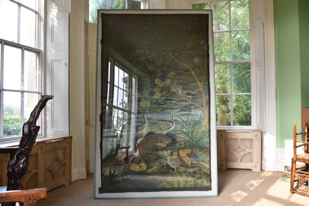 A large nineteenth-century framed Asian wall hanging painted with birds, blooming flowers, and foliage on a muted green background.
