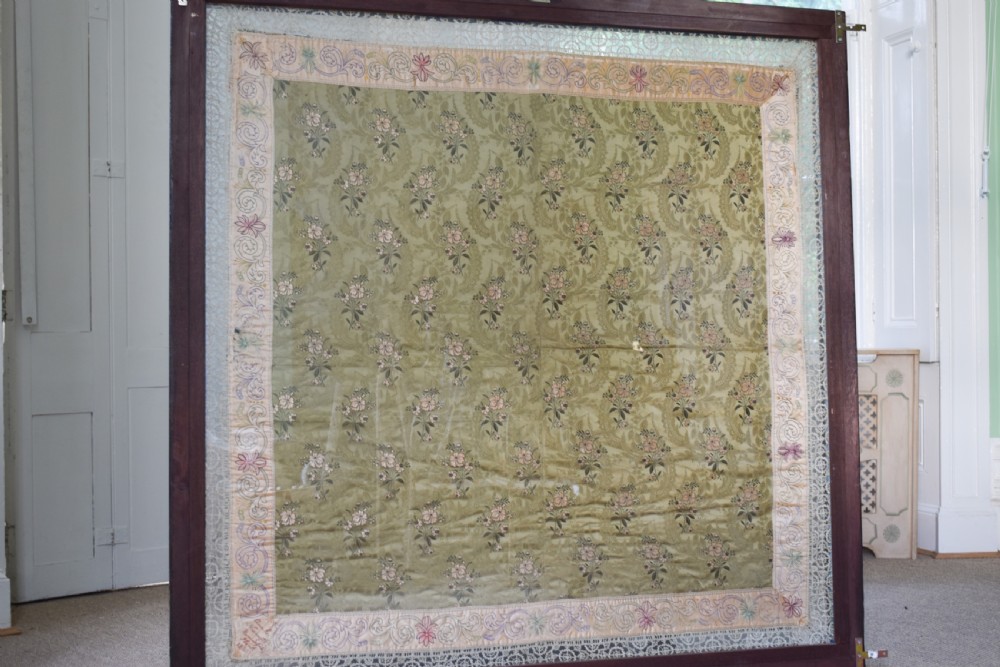 A large square framed Victorian silk patchwork panel featuring octagonal segments with intricate embroidered floral motifs and a dated section in the corner. View VII