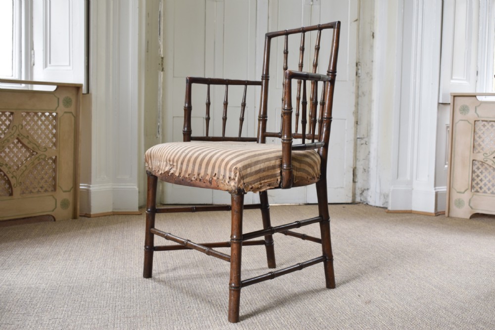 A dark-stained wooden armchair featuring simulated bamboo turnings across the frame and backrest, fitted with a striped fabric seat. View IV