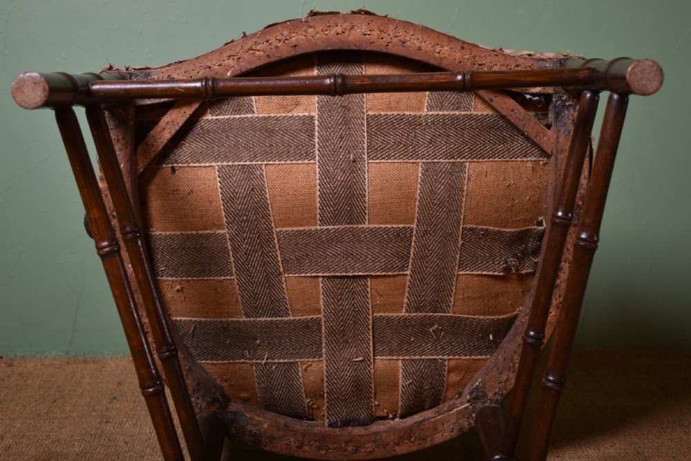A dark-stained wooden armchair featuring simulated bamboo turnings across the frame and backrest, fitted with a striped fabric seat. View VI