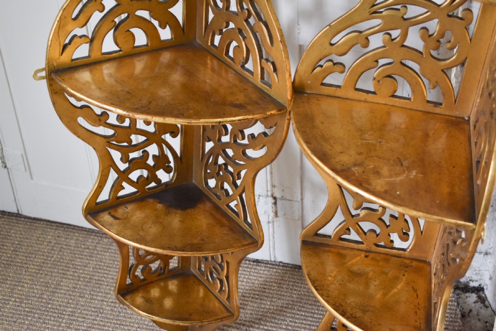 A pair of tall Victorian giltwood corner shelves with elaborate pierced fretwork design and multiple tiers. View II