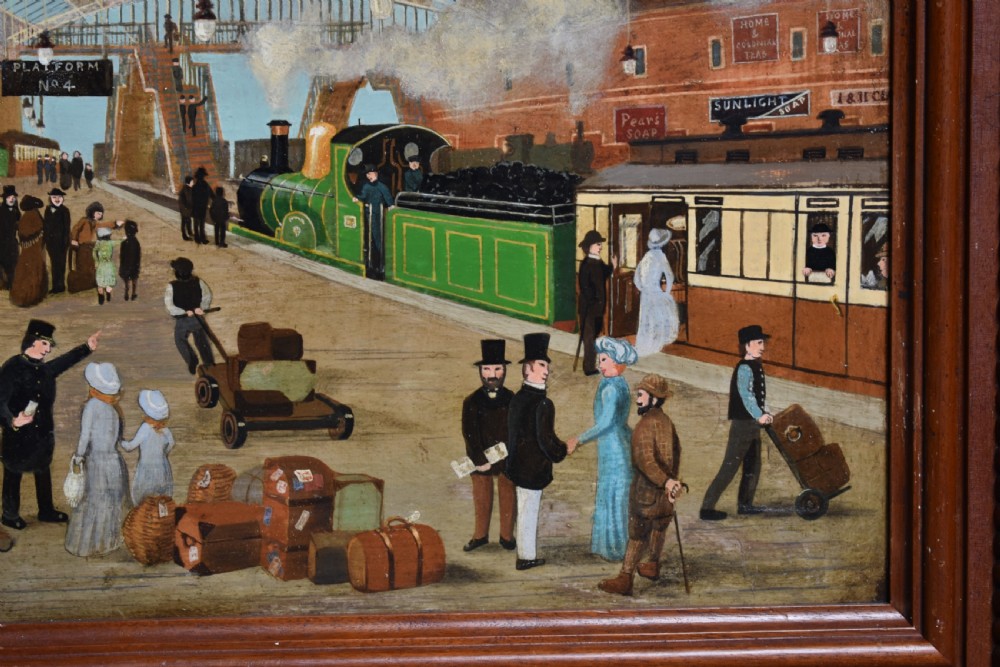 An oil painting on board depicting a busy Victorian steam train station scene inside a heavy bobbin-turned wood frame. View V
