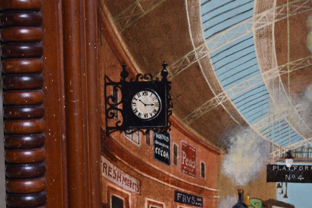 An oil painting on board depicting a busy Victorian steam train station scene inside a heavy bobbin-turned wood frame. View VII