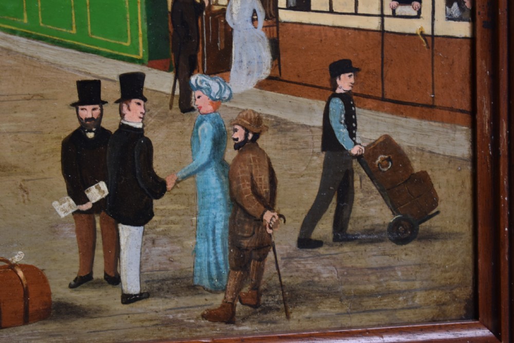 An oil painting on board depicting a busy Victorian steam train station scene inside a heavy bobbin-turned wood frame. View VIII