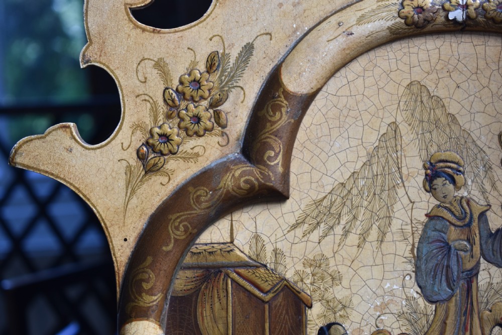 A tall, narrow Queen Anne style mirror featuring an arched frame decorated with chinoiserie hand-painted scenes, a carved gilt shell cresting, and ochre yellow lacquered borders. View V