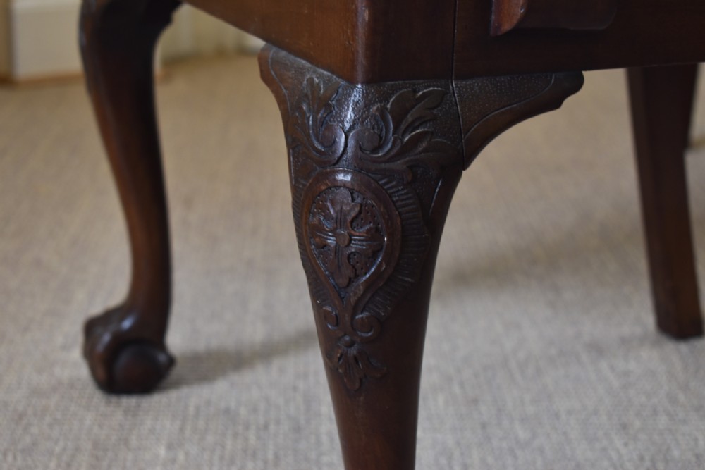 A pair of dark mahogany open armchairs featuring geometric floral fretwork backrests, open carved arms, cream upholstered seats, and cabriole legs with claw and ball feet. View V