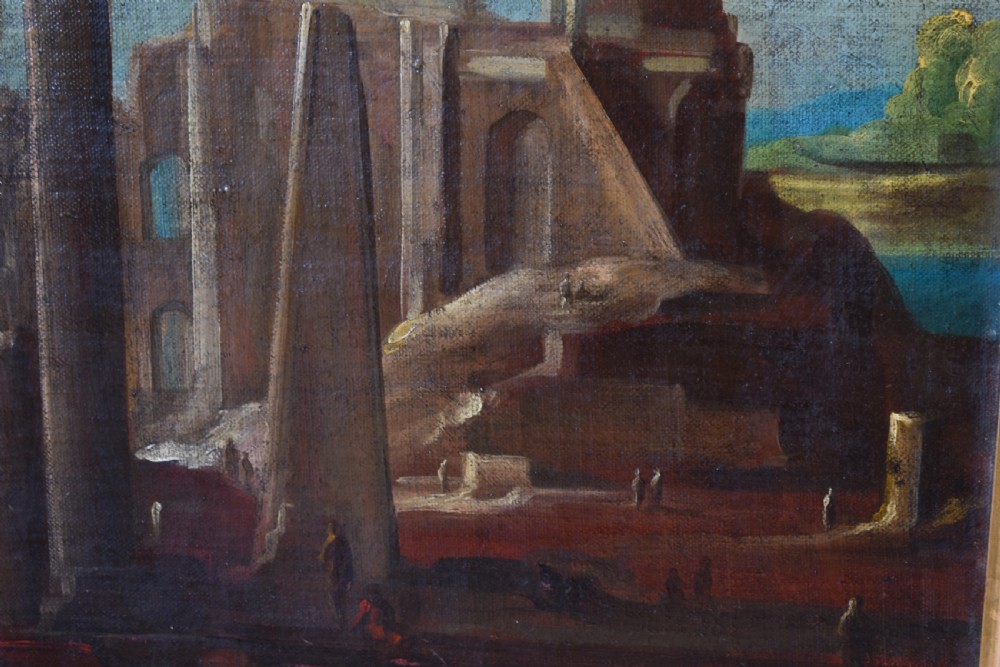 An antique oil painting depicting classical architectural ruins with columns and an obelisk set within a wide gold gilt frame. View II