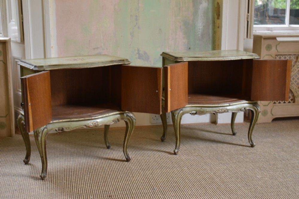 A pair of sage green French painted bedside cabinets with floral hand-painting, gilt scroll mouldings, double doors, and cabriole legs. View VII
