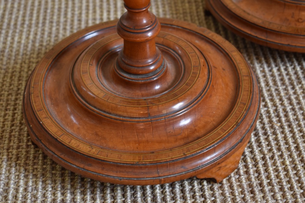 A pair of tall, slender antique satinwood candle stands featuring circular tray tops, fluted turned columns, and circular molded bases. View III