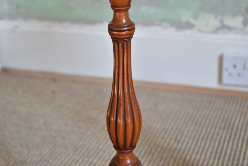 A pair of tall, slender antique satinwood candle stands featuring circular tray tops, fluted turned columns, and circular molded bases. View IV