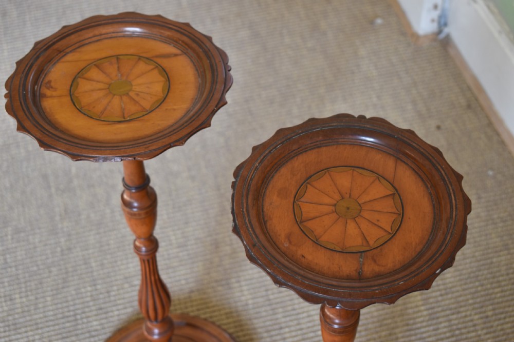 A pair of tall, slender antique satinwood candle stands featuring circular tray tops, fluted turned columns, and circular molded bases. View VI
