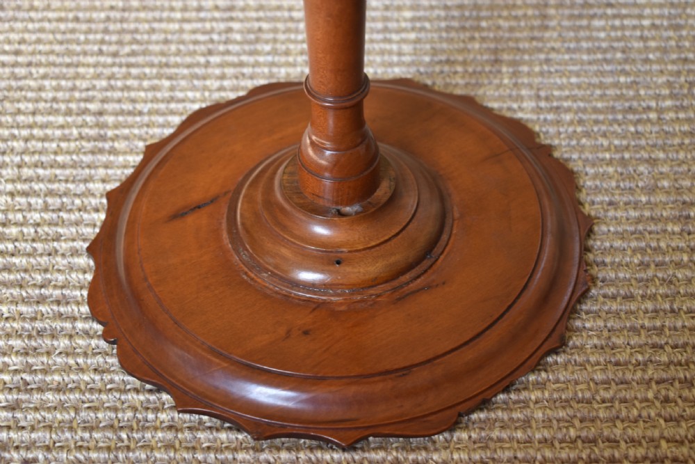 A pair of tall, slender antique satinwood candle stands featuring circular tray tops, fluted turned columns, and circular molded bases. View VIII