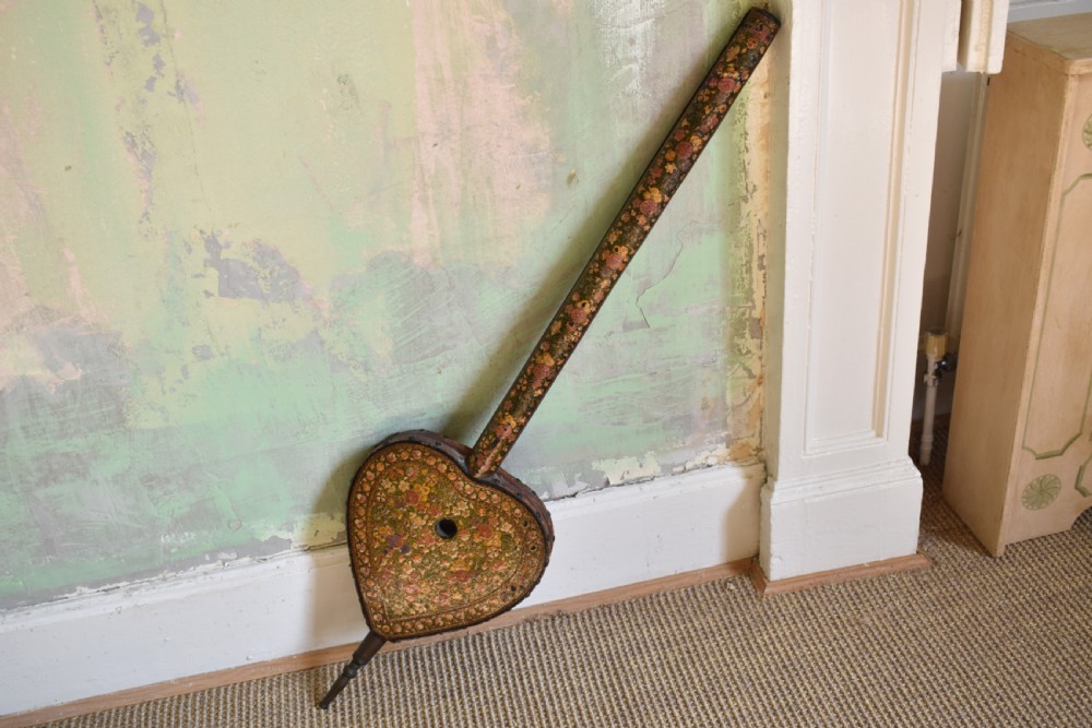 A long-handled Kashmiri fire bellows decorated with hand-painted floral lacquered motifs and a metal nozzle.