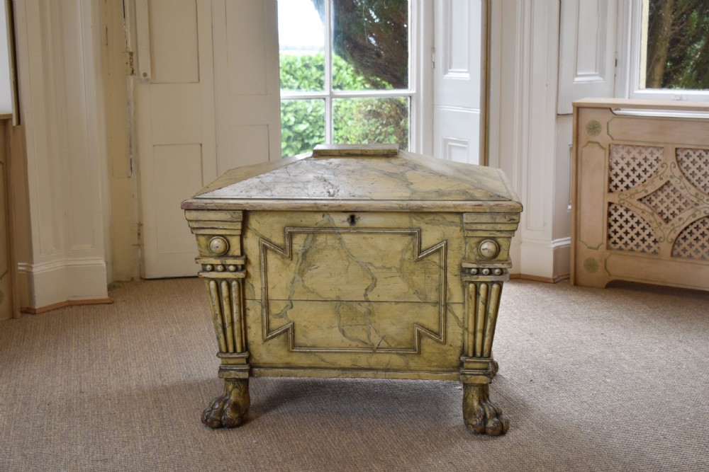 A Regency sarcophagus-form cellaret decorated with faux marble painted timber, fluted corner columns, and carved lion paw feet. View IV