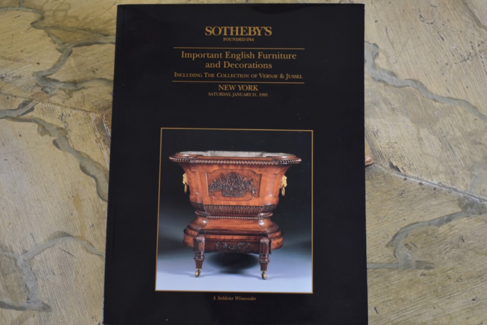 A Regency sarcophagus-form cellaret decorated with faux marble painted timber, fluted corner columns, and carved lion paw feet. View VIII