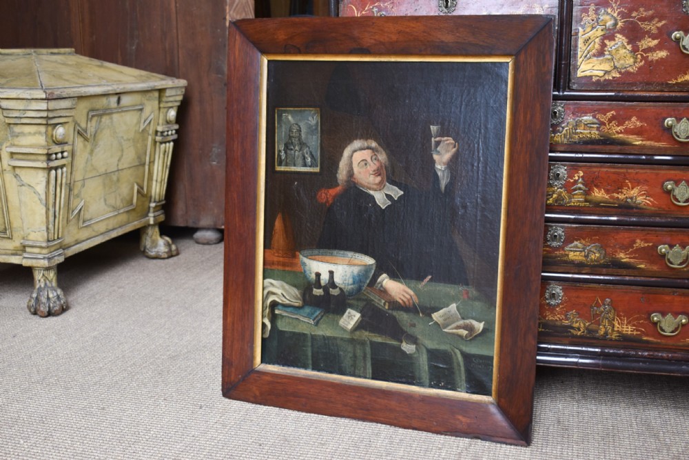 An eighteenth-century oil painting depicting a clergyman seated at a draped table with a punch bowl and glass, encased in a dark wooden frame with a gilded inner slip. View II