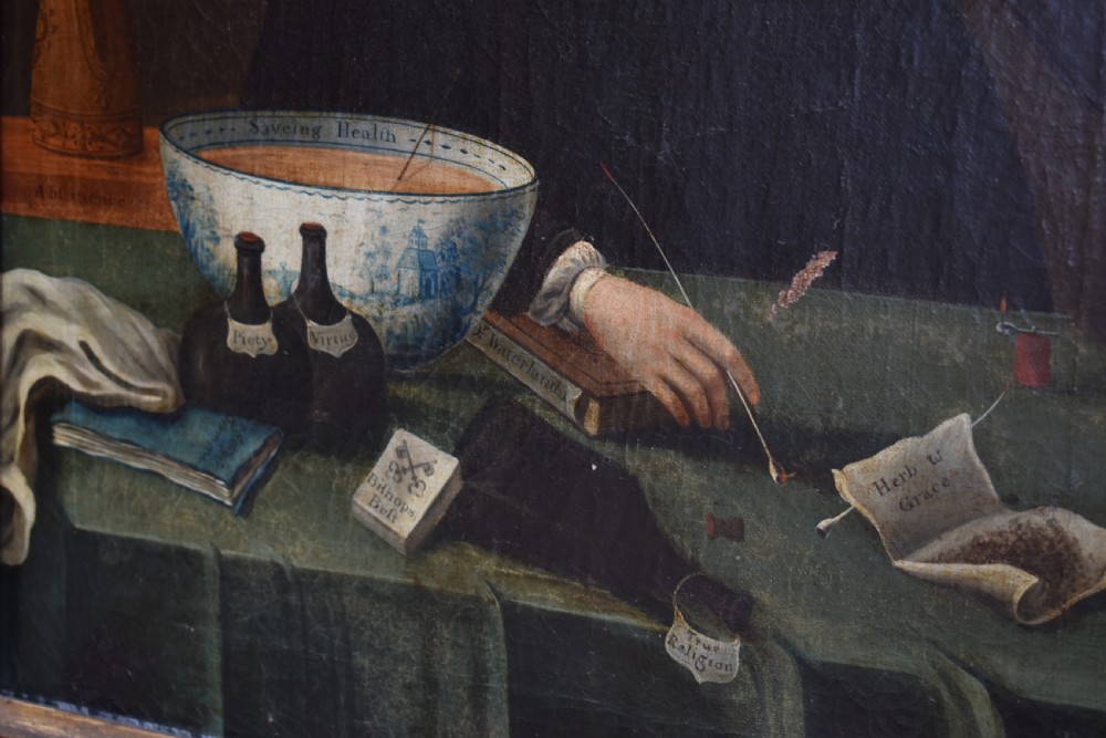 An eighteenth-century oil painting depicting a clergyman seated at a draped table with a punch bowl and glass, encased in a dark wooden frame with a gilded inner slip. View IV