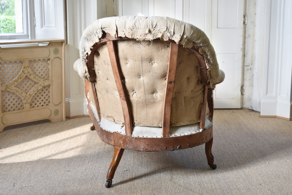 A Victorian upholstered chaise longue with deep-buttoned backrest, carved mahogany frame, and castors on cabriole legs. View VII