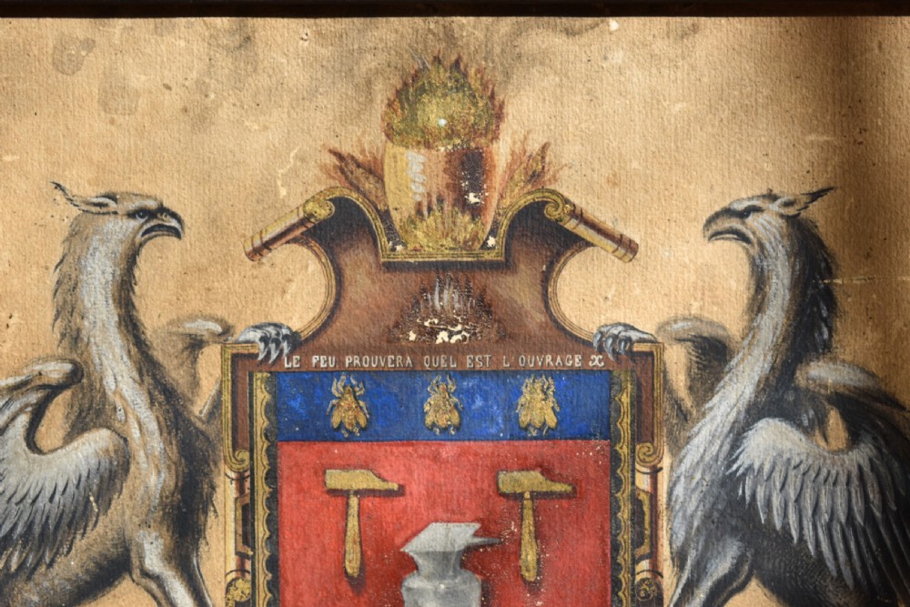 A framed 18th-century heraldic artwork displaying a central coat of arms with anvil motifs flanked by two heraldic griffin supporters. View II