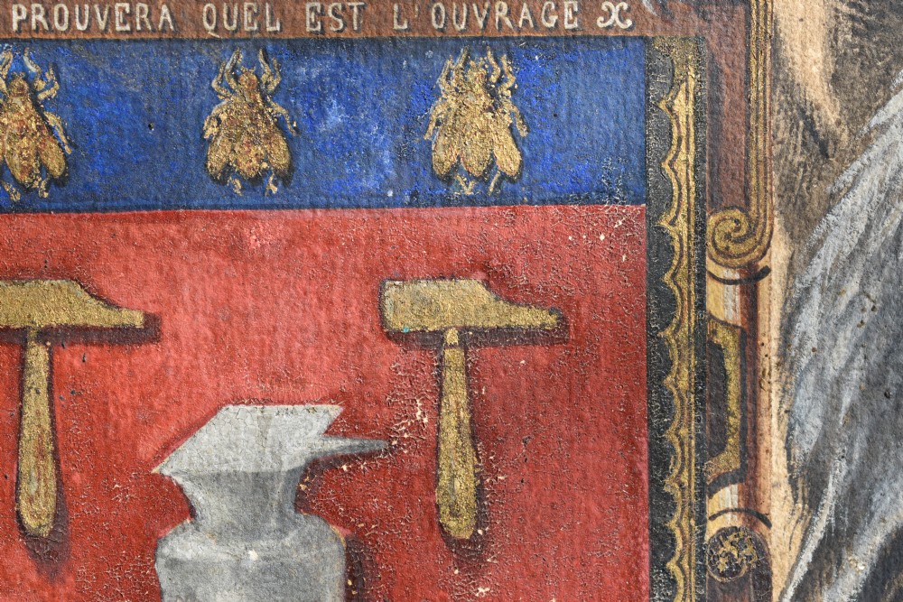 A framed 18th-century heraldic artwork displaying a central coat of arms with anvil motifs flanked by two heraldic griffin supporters. View VI