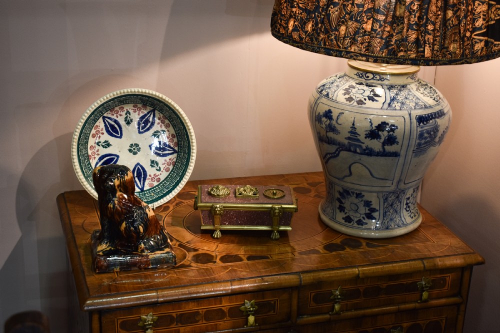 A Chinese blue and white ceramic baluster vase fitted as a table lamp with a navy and gold pleated patterned fabric shade. View II