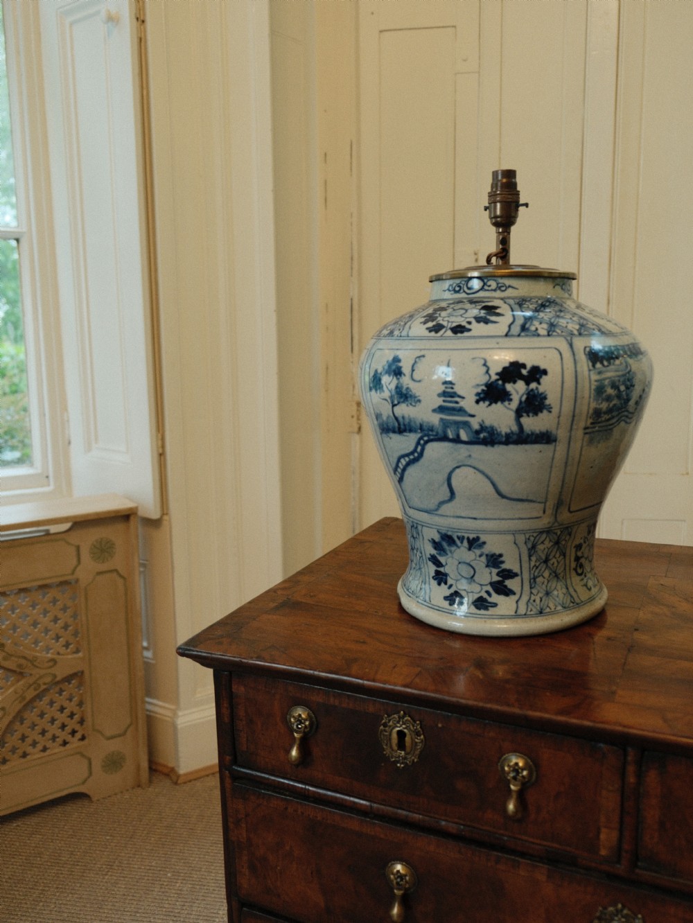 A Chinese blue and white ceramic baluster vase fitted as a table lamp with a navy and gold pleated patterned fabric shade. View IV
