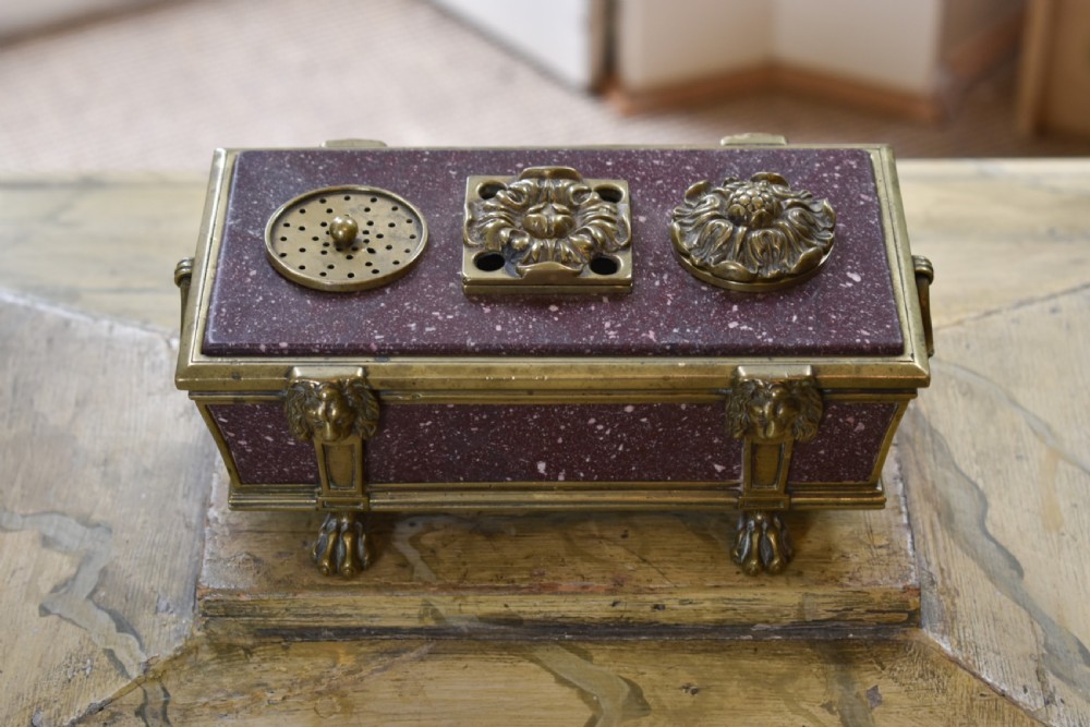 A Regency period sarcophagus-form porphyry inkstand with gilt bronze lion feet, side drop handles, and brass inkwell covers. View III