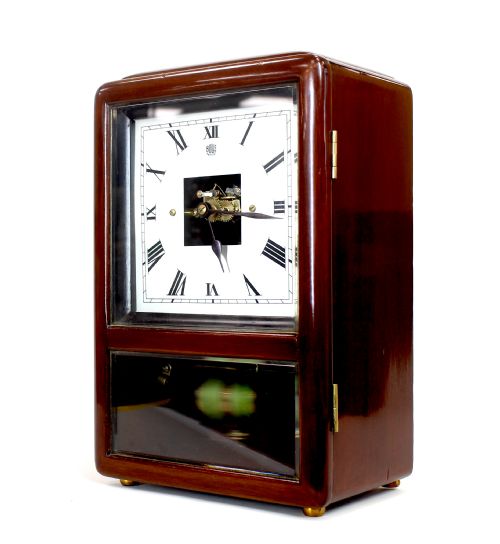 fig 1. An Art Deco Bulle electric mantel clock featuring a dark mahogany case, white square dial with Roman numerals, exposed movement centre, and visible green electromagnetic coil pendulum.