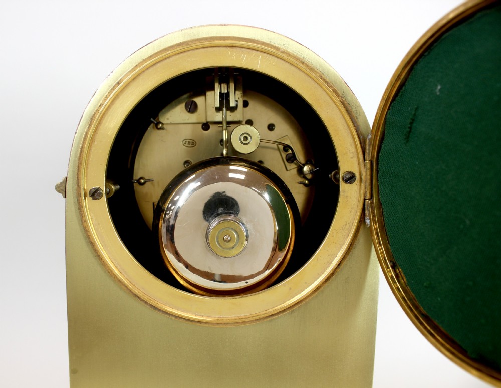 A polished brass dome-topped mantel clock featuring a white enamel dial with Roman numerals on a stepped rectangular base. View II