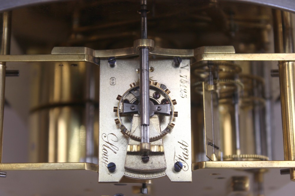 A chrome-plated nautical desk clock styled as a ship wheel mounted on a rectangular plinth with a cream dial and Roman numerals. View VII