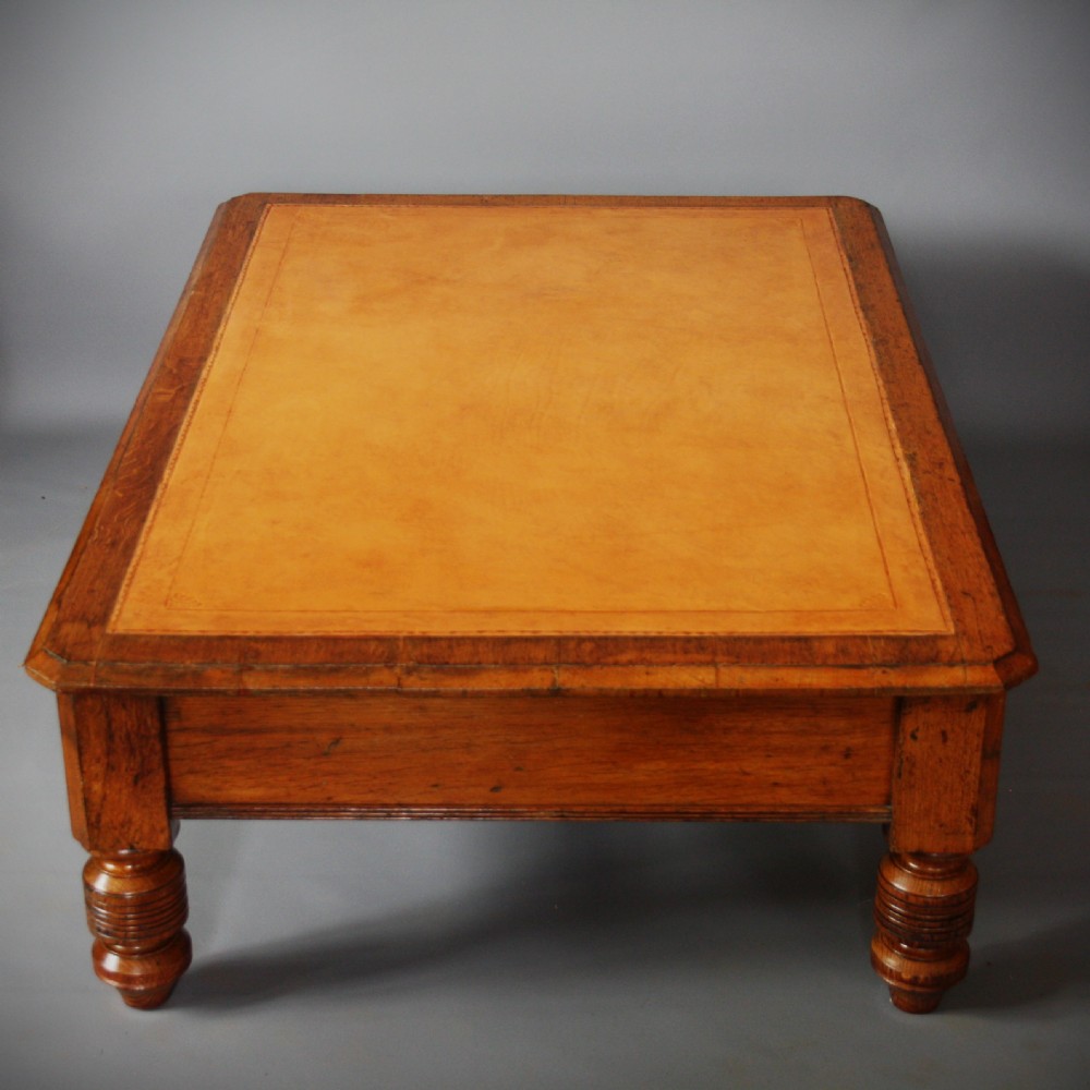 A low rectangular golden oak coffee table featuring a leather inset top, two front drawers with turned wooden knobs, and stout turned legs. View IV