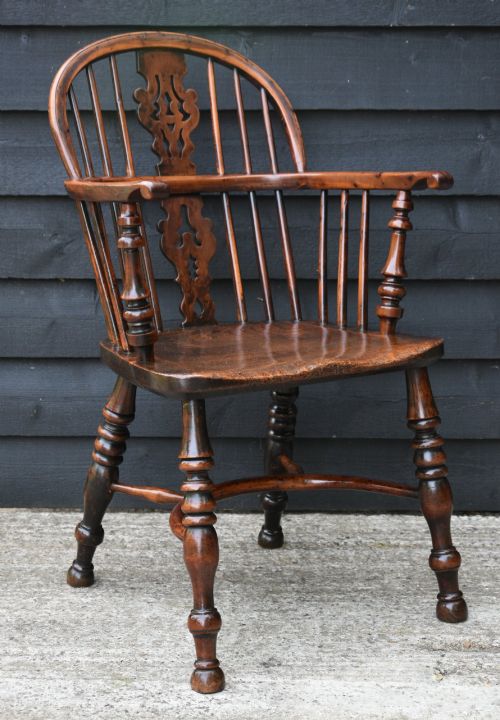 fig 1. A matched pair of 18th-century Georgian yew and elm Windsor armchairs featuring curved hoop backs, pierced central splats, saddle seats, and turned legs.