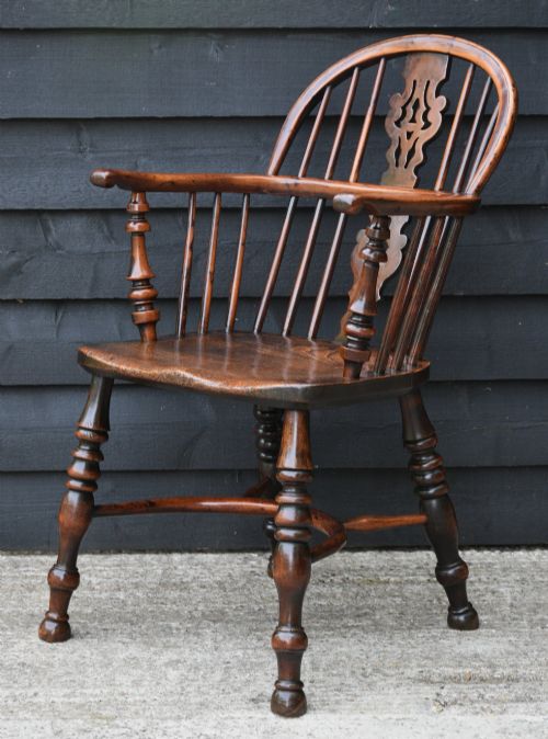 fig 2. A matched pair of 18th-century Georgian yew and elm Windsor armchairs featuring curved hoop backs, pierced central splats, saddle seats, and turned legs.