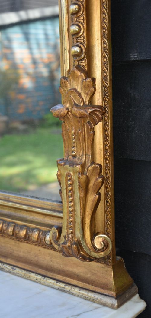 A 19th-century French giltwood pier mirror with an ornate shell crest mounted above a matching carved console table featuring a marble top. View VII