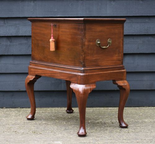 fig 1. A nineteenth-century mahogany storage box set on a matching stand with carved cabriole legs and brass side handles.