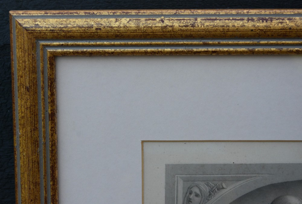 A framed nineteenth-century monochrome engraving depicting a seated woman in draped classical attire inside an arched niche, presented in a gold gilt frame. View IV
