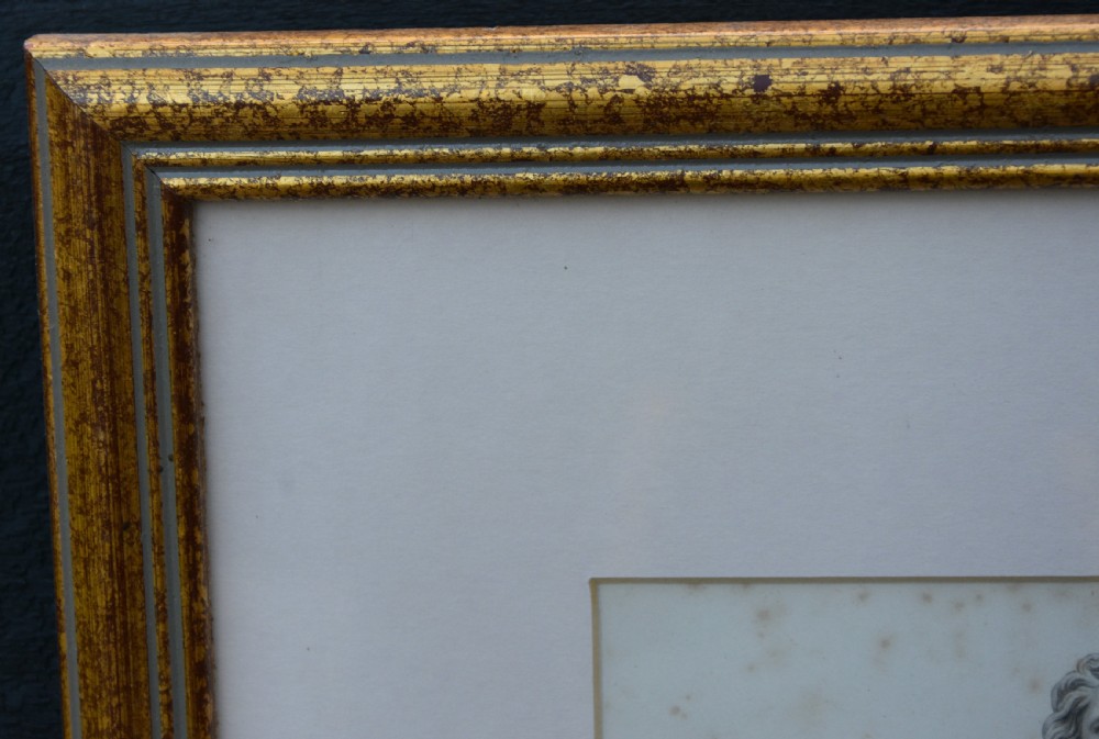 A framed 19th-century monochrome portrait engraving depicting a full-length statue of John Hampden set within a cream mount and a slim gold-leaf wooden frame. View V