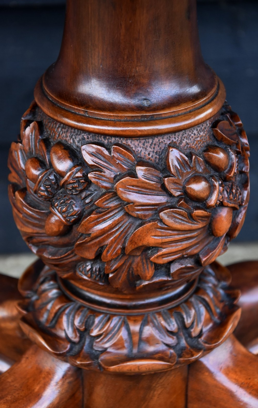 A Victorian burr walnut foldover card table featuring a rectangular swivel top, carved apron accent, turned pedestal stem with floral carving, and four cabriole legs ending in claw and ball feet. View VIII