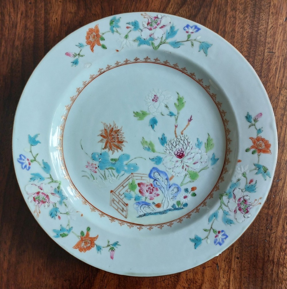 An 18th-century Chinese Qianlong period Famille Rose porcelain plate decorated with hand-painted polychrome floral motifs and rockwork.