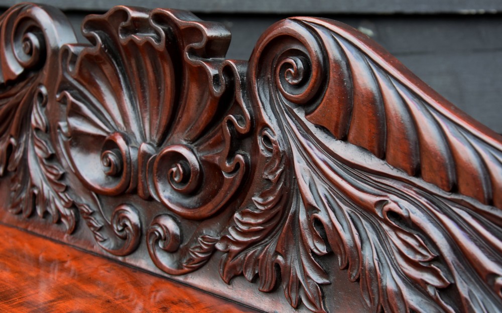 A Regency mahogany chiffonier side cabinet featuring a carved cresting gallery shelf, flame mahogany cupboard doors, and turned feet. View VII