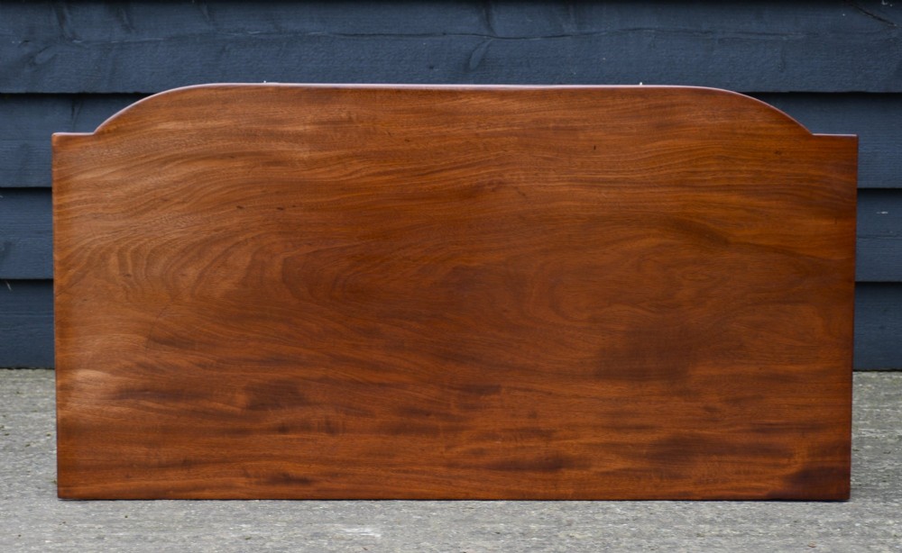 A Regency mahogany bow-fronted side table featuring a central drawer with circular brass handles and slender turned legs. View VII