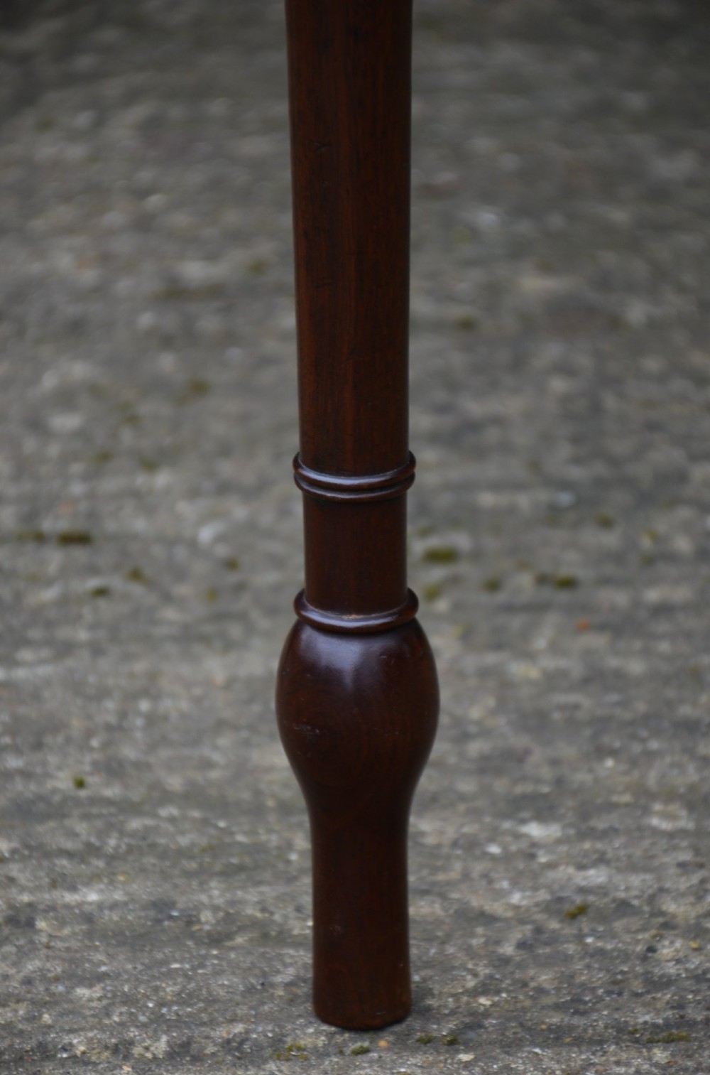 A Regency mahogany bow-fronted side table featuring a central drawer with circular brass handles and slender turned legs. View IX
