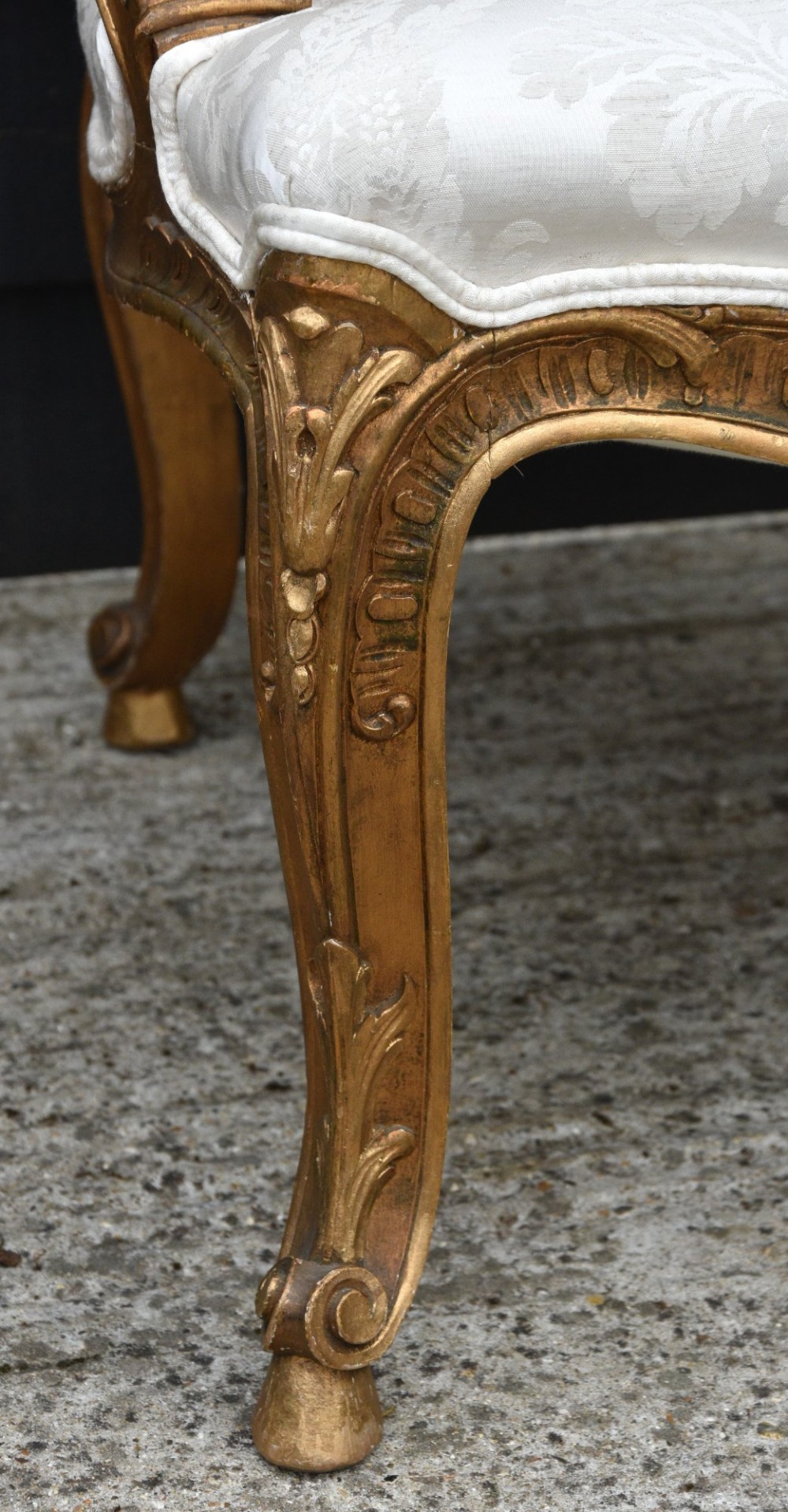 Pair of late 19th-century French giltwood armchairs upholstered in cream damask with carved cresting and cabriole legs. View VI