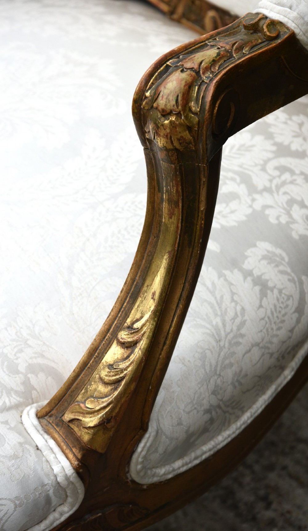 Pair of late 19th-century French giltwood armchairs upholstered in cream damask with carved cresting and cabriole legs. View VII