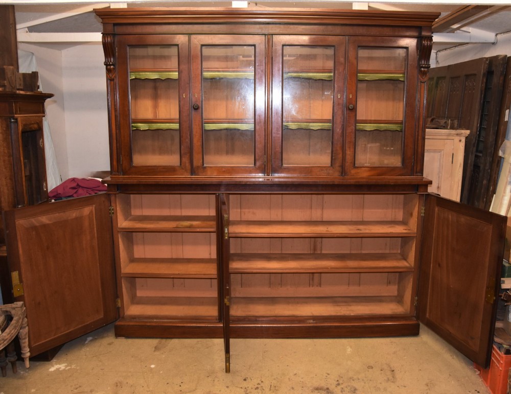 A large William IV mahogany triple bookcase cabinet featuring four upper glazed doors and three lower solid panelled doors. View III
